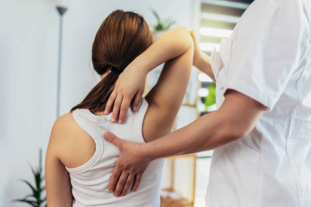Woman receiving healing chiropractic treatment for back pain
