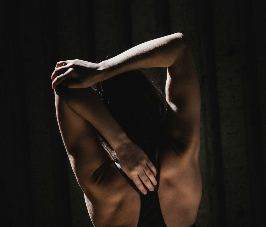 Woman stretching her arms above her head.
